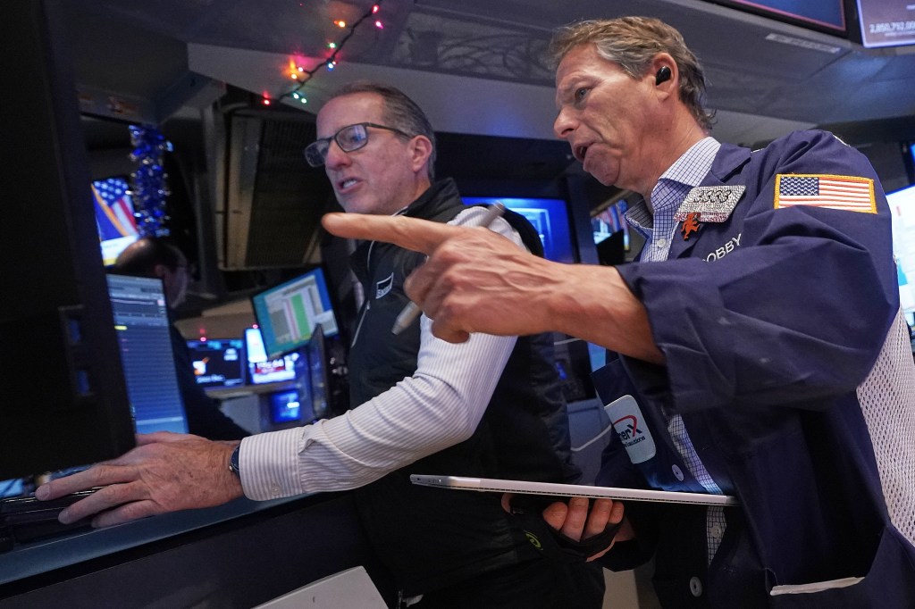Specialist Glenn Carell and trader Robert Charmak work on the floor of the New York Stock Exchange.