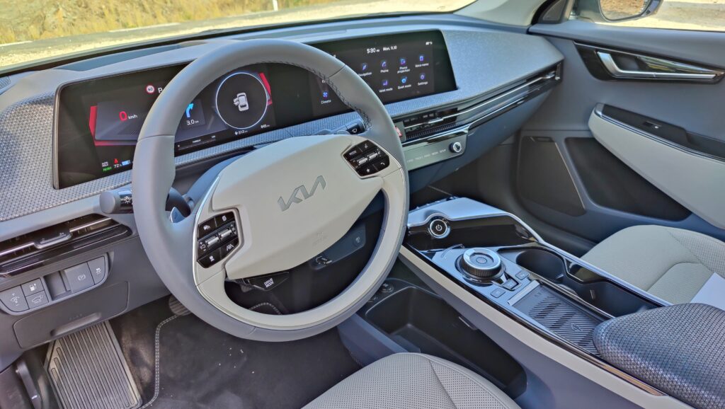 View into the EV6 from the driver's door, showing seat and wheel