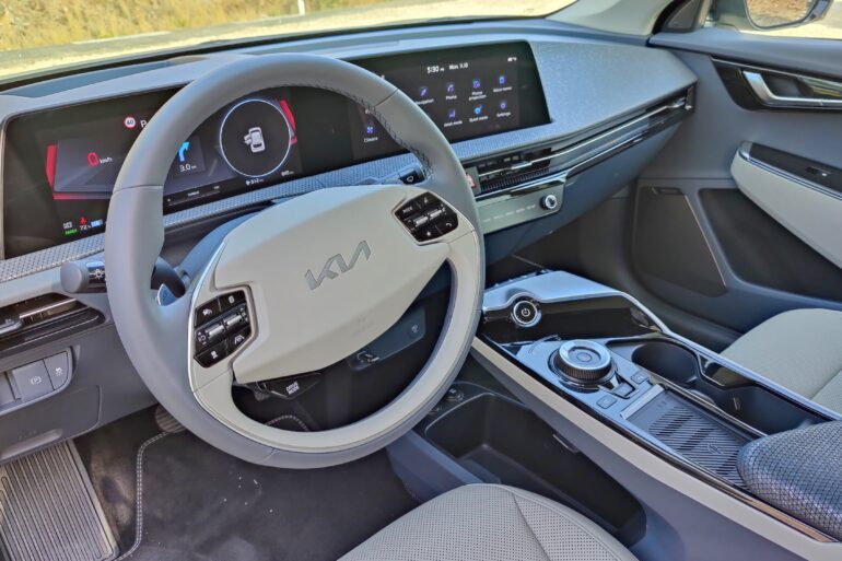 View into the EV6 from the driver's door, showing seat and wheel