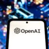 The OpenAI logo is displayed on a smartphone as the company’s stock-based compensation reaches levels unmatched by any major tech startup before an IPO.