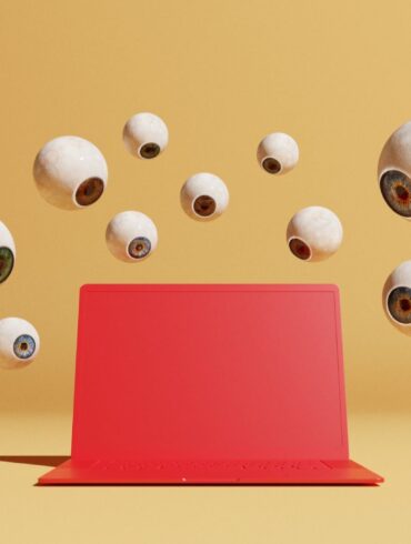 Conceptual image with a bunch of floating eyeballs in different sizes overlooking a red computer, could symbolize ideas around malware and computer viruses