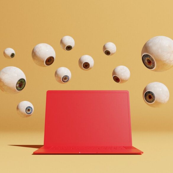 Conceptual image with a bunch of floating eyeballs in different sizes overlooking a red computer, could symbolize ideas around malware and computer viruses