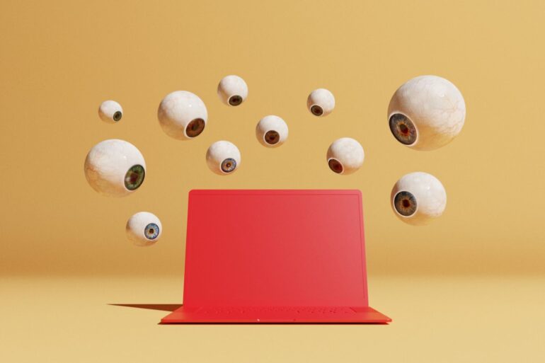 Conceptual image with a bunch of floating eyeballs in different sizes overlooking a red computer, could symbolize ideas around malware and computer viruses
