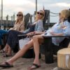 The Sinclair sisters sit on deck chairs in We Were Liars season 1