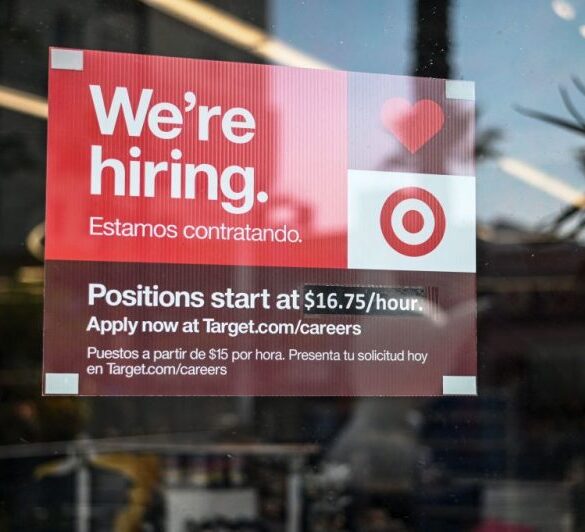 A sign advertising for new employees with an updated starting salary of USD $16.75 per hour is seen in the window of a Target store in Hollywood, California on November 9, 2021. - Even as millions of Americans who lost their jobs to the Covid-19 pandemic have returned to work, companies nationwide report they're still struggling to hire employees in recent months. More than 10 million jobs were unfilled as of the end of August, according to government data. (Photo by Robyn Beck / AFP) (Photo by ROBYN BECK/AFP via Getty Images)