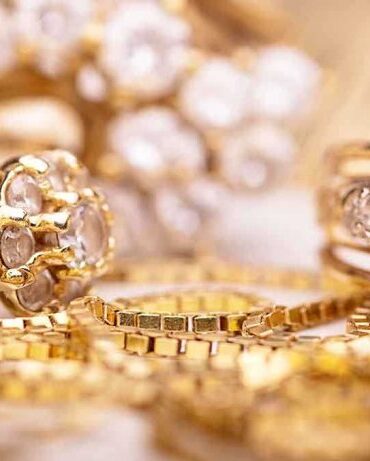 Close-up of various gold rings adorned with sparkling gems