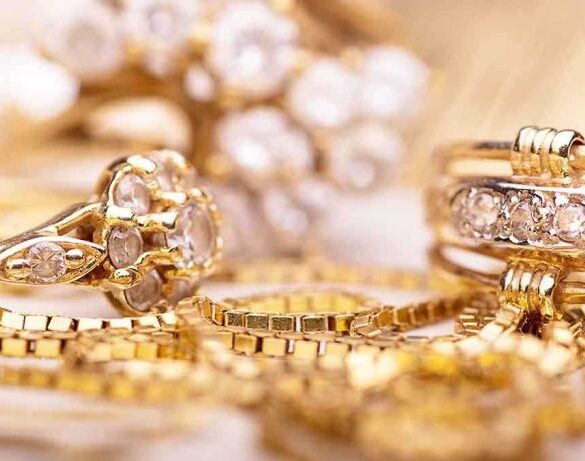 Close-up of various gold rings adorned with sparkling gems