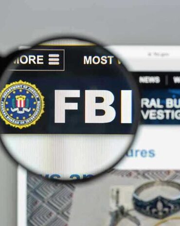 FBI website shown through magnifying glass.