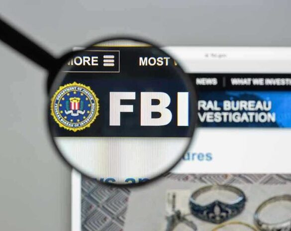 FBI website shown through magnifying glass.