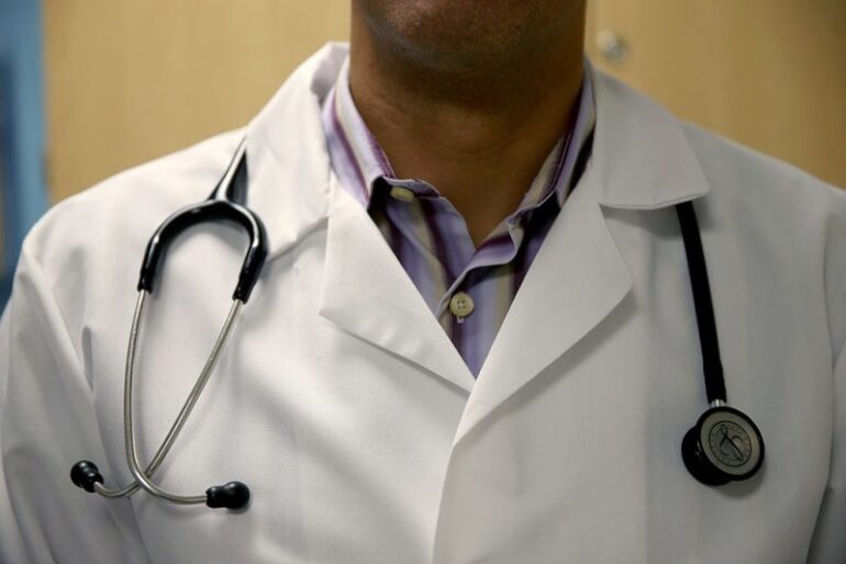 MIAMI, FL - JUNE 02: A doctor wears a stethoscope as he see a patient for a measles vaccination during a visit to the Miami Children's Hospital on June 02, 2014 in Miami, Florida. The Centers for Disease Control and Prevention last week announced that in the United States they are seeing the most measles cases in 20 years as they warned clinicians, parents and others to watch for and get vaccinated against the potentially deadly virus. (Photo by Joe Raedle/Getty Images)