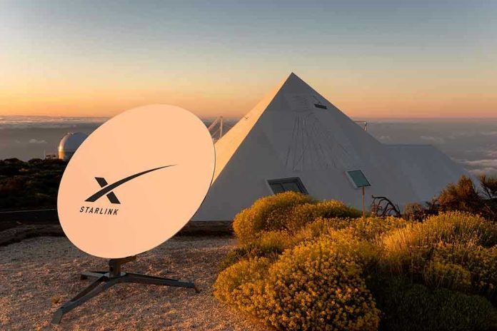 Satellite dish near pyramid-shaped building at sunset.
