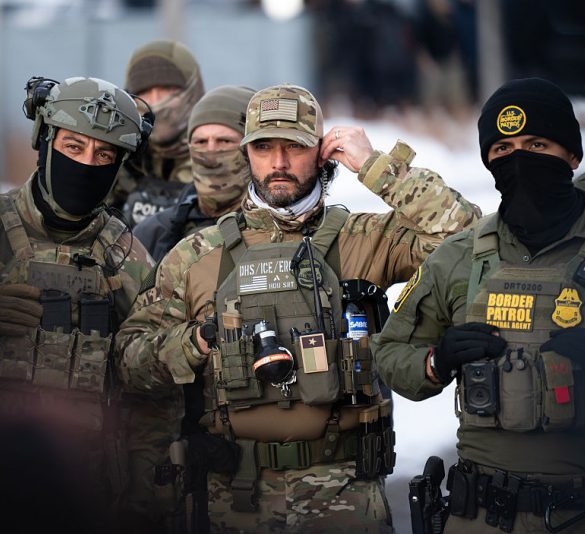 MINNEAPOLIS, MINNESOTA - JANUARY 10: Federal agents stage at a front gate as Rep. Ilhan Omar (D-MN), Rep. Kelly Morrison (D-MN), and Rep. Angie Craig (D-MN) attempt to enter the regional ICE headquarters at the Bishop Henry Whipple Federal Building on January 10, 2026 in Minneapolis, Minnesota. The Congresspeople were briefly allowed access to the facility where the Department of Homeland Security has been headquartering operations in the state. (Photo by Stephen Maturen/Getty Images)