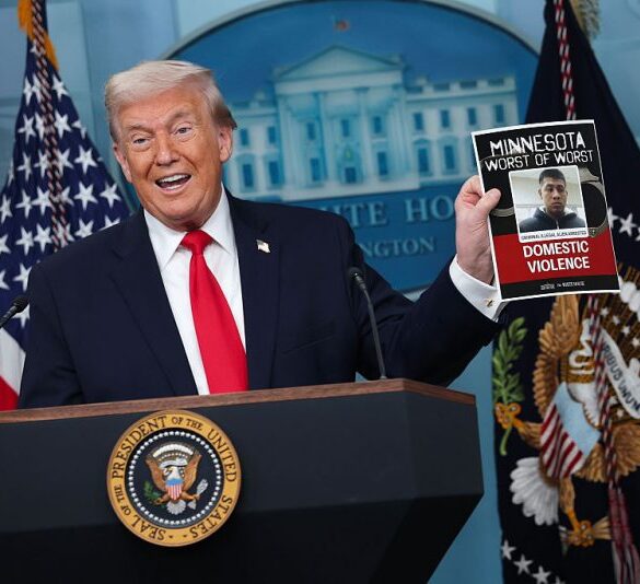 WASHINGTON, DC - JANUARY 20: U.S. President Donald Trump displays a photo of what he says is an illegal immigrant who was arrested in Minnesota during a press briefing in the James S. Brady Press Briefing Room of the White House on January 20, 2026 in Washington, DC. White House Press Secretary Karoline Leavitt was joined by President Trump days after the president threatened a 10% import tax on goods from eight European countries that have rallied around Denmark amid Trump's calls for the U.S. to take control of Greenland, a semi-autonomous Danish territory. (Photo by Kevin Dietsch/Getty Images)