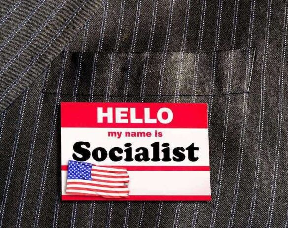 Hello my name is Socialist name tag on suit.