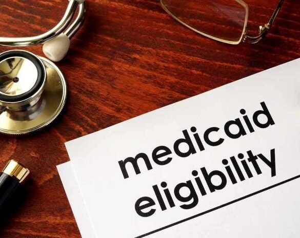 Stethoscope pen document about Medicaid eligibility on table