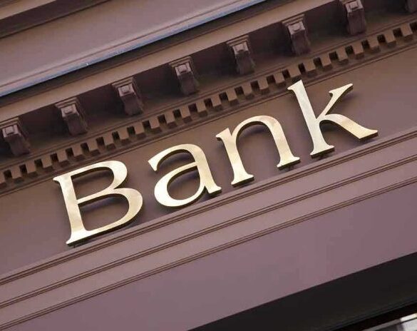 Gold bank sign on building facade