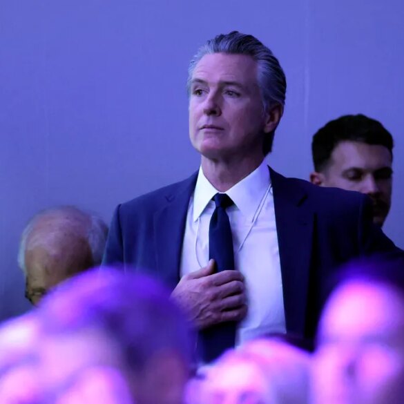 Gavin Newsom, governor of California, watches as Donald Trump speaks at the World Economic Forum.