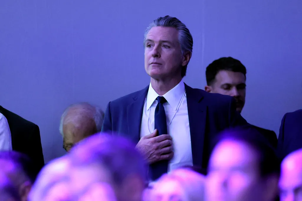 Gavin Newsom, governor of California, watches as Donald Trump speaks at the World Economic Forum.