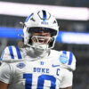 Politics: duke sues its quarterback in bid to keep him