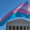 Transgender pride flag waving above the US Supreme Court building.