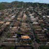 Aerial view of Pacific Palisades, California showing many homes under reconstruction in a fire-ravaged neighborhood.