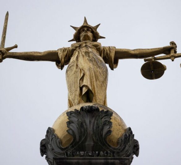 LONDON, ENGLAND - JANUARY 19: A statue of the Scales of Justice stands above the Old Bailey on January 19, 2021 in London, England. Criminal watchdogs representing England and Wales have expressed concern over the backlog of cases, caused by the Coronavirus pandemic. Figures have revealed that the backlog of unheard cases in the crown courts has reached 54,000. (Photo by Dan Kitwood/Getty Images)