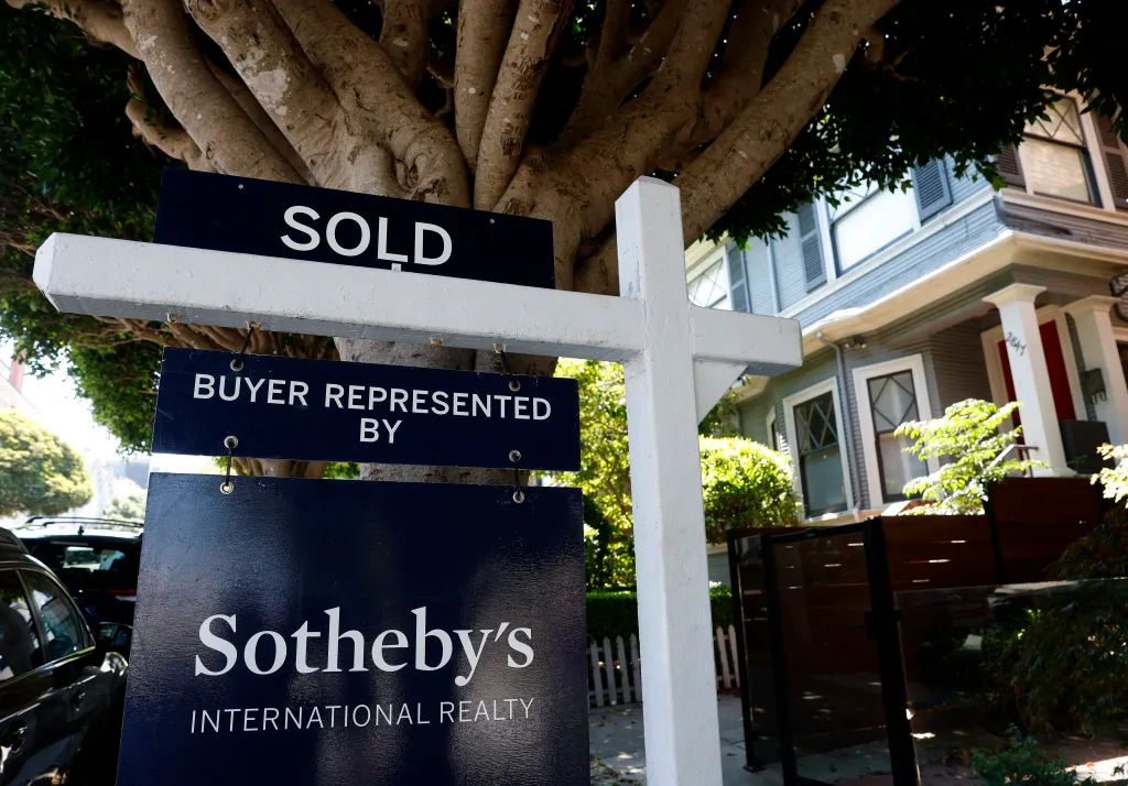 A "SOLD" sign from Sotheby's International Realty in front of a home.