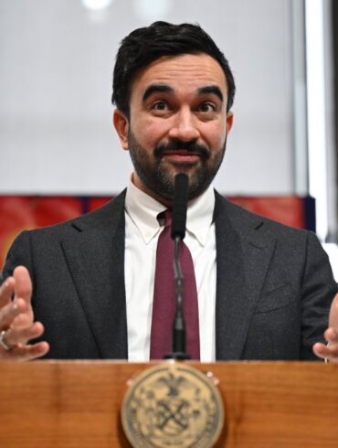 Mayor Zohran Mamdani making a junk fees-related announcement at a press conference.