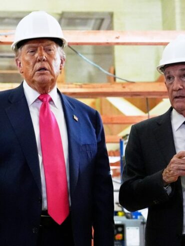 President Donald Trump speaks with Federal Reserve Chairman Jerome Powell during a visit to the Federal Reserve, Thursday, July 24, 2025, in Washington.