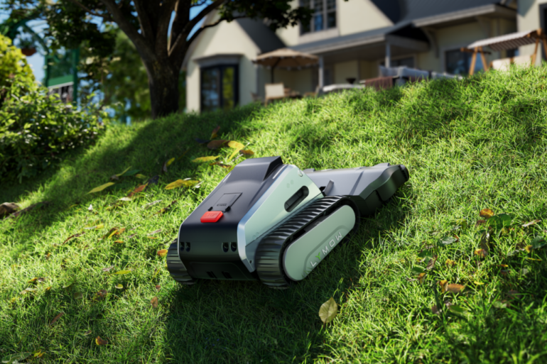 Illustration of a robotic lawn mower with tracks on a grassy hill with a house in the background.