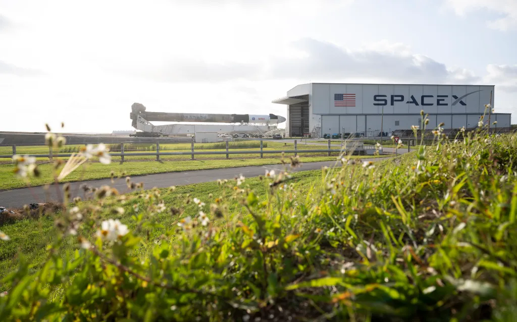 SpaceX Falcon 9 rocket and Crew Dragon spacecraft being rolled out to Launch Complex 39A.