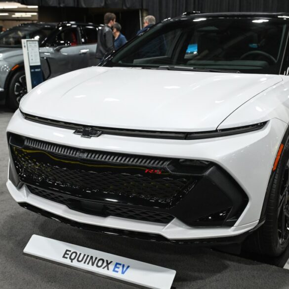A white 2025 Chevrolet Equinox EV on display.