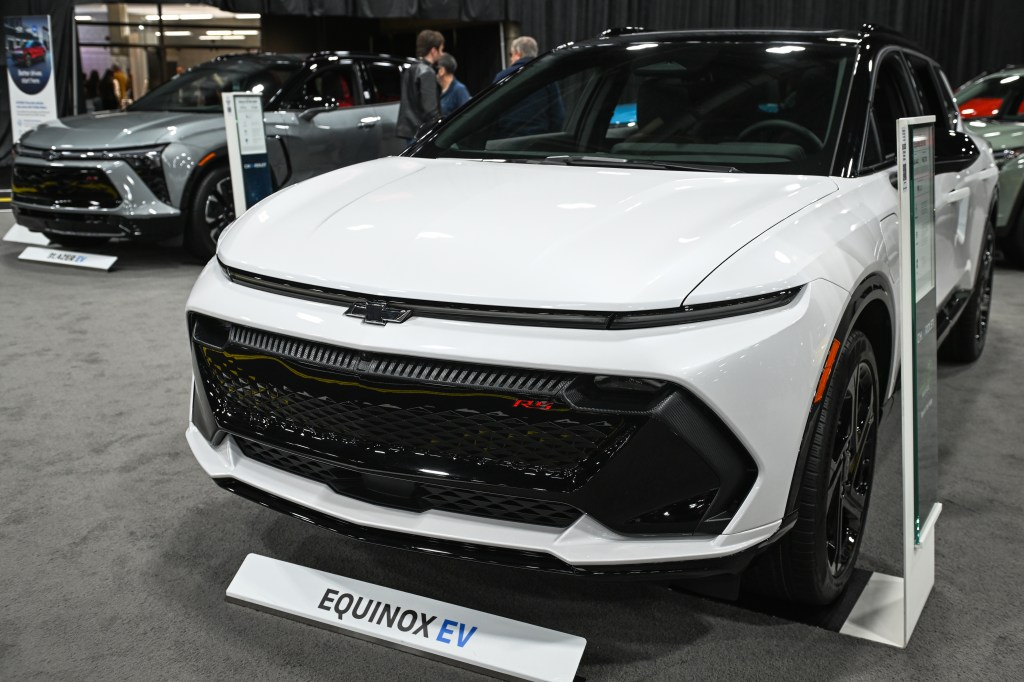 A white 2025 Chevrolet Equinox EV on display.