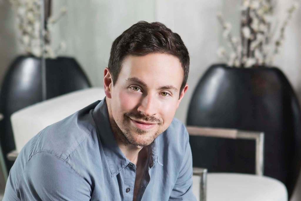 Ryan Cohen, co-founder of Chewy.com, sitting and smiling.