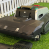 Lymow robotic lawnmower with tracks on artificial grass.