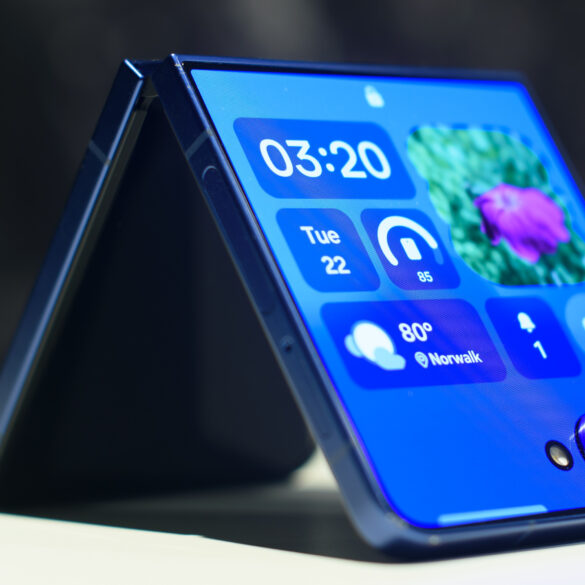 Samsung Galaxy Z Flip 7 in blue folded showing widgets on the cover display