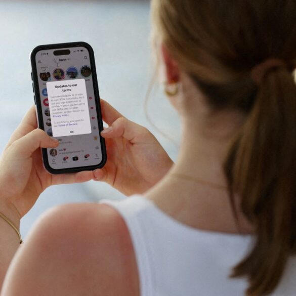 Teen holding a mobile phone.