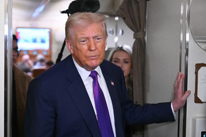 US President Donald Trump speaks to reporters on Air Force One before taking off from Joint Base Andrews, Maryland on February 19, 2026. Trump is travelling to Rome, Georgia to visit local businesses and give remarks about the economy at a steel factory. (Photo by SAUL LOEB / AFP via Getty Images)