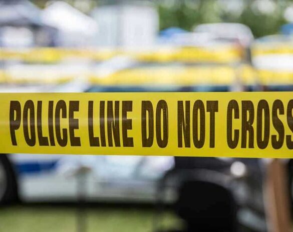 Yellow police line tape with Do Not Cross.