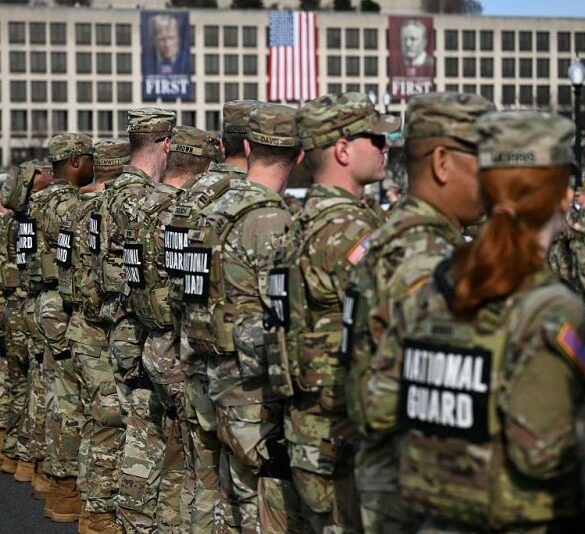 Members of the National Guard look on during a procession for Metropolitan Police Department (MPD) officer Terry Bennett, who passed away on January 7 after being struck on a highway while helping a stranded driver on December 23, 2025, in Washington, DC, on January 8, 2026. (Photo by Brendan SMIALOWSKI / AFP via Getty Images)