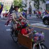 A person representing Scouting America rides a bicycle with children during the WorldPride 2025 parade in support of LGBTQ+ rights in Washington, D.C. on June 7, 2025. (Photo by Bryan Dozier / Middle East Images via AFP) (Photo by BRYAN DOZIER/Middle East Images/AFP via Getty Images)