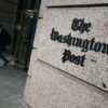 A man exits the Washington Post office building in Washington, DC, on February 4, 2026. The Washington Post, owned by billionaire Amazon founder Jeff Bezos, announced major job cuts on February 4, saying that "painful" restructuring was needed at the storied newspaper. The Post, which gained legendary status when it helped bring down president Richard Nixon in the Watergate scandal, will see "substantial" reductions in its newsroom, which until now had an estimated 800 journalists, Executive Editor Matt Murray said. (Photo by Oliver Contreras / AFP via Getty Images)