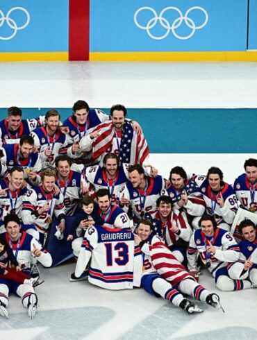 TOPSHOT - Gold medallists USA's players pose during the medals ceremony of the men's ice hockey event at the Milano Santagiulia Ice Hockey Arena during the Milano Cortina 2026 Winter Olympic Games in Milan, on February 22, 2026. (Photo by JULIEN DE ROSA / AFP via Getty Images)