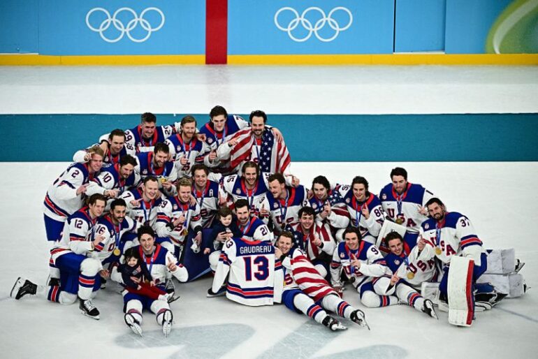 TOPSHOT - Gold medallists USA's players pose during the medals ceremony of the men's ice hockey event at the Milano Santagiulia Ice Hockey Arena during the Milano Cortina 2026 Winter Olympic Games in Milan, on February 22, 2026. (Photo by JULIEN DE ROSA / AFP via Getty Images)