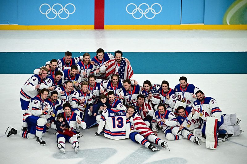 TOPSHOT - Gold medallists USA's players pose during the medals ceremony of the men's ice hockey event at the Milano Santagiulia Ice Hockey Arena during the Milano Cortina 2026 Winter Olympic Games in Milan, on February 22, 2026. (Photo by JULIEN DE ROSA / AFP via Getty Images)
