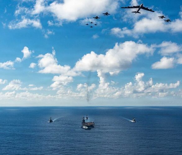 AT SEA- NOVEMBER 13: In this handout provided by the U.S. Navy, The U.S. Navy's Gerald R. Ford Carrier Strike Group, including the flagship USS Gerald R. Ford (CVN 78), front, USS Winston S. Churchill (DDG 81), right, USS Mahan (DDG 72), left, USS Bainbridge (DDG 96), and embarked Carrier Air Wing Eight F/A-18E/F Super Hornets assigned to Strike Fighter Squadrons 31, 37, 87, and 213, operates as a joint, multi-domain force with a U.S. Air Force B-52 Stratofortress, November 13, 2025. U.S. military forces, like the Gerald R. Ford Carrier Strike Group, are deployed in support of the U.S. Southern Command mission, Department of War-directed operations, and the President's priorities to disrupt illicit drug trafficking and protect the homeland. (Photo by Gladjimi Balisage/US Navy via Getty Images)