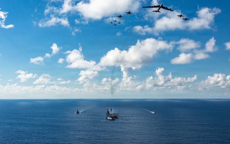 AT SEA- NOVEMBER 13: In this handout provided by the U.S. Navy, The U.S. Navy's Gerald R. Ford Carrier Strike Group, including the flagship USS Gerald R. Ford (CVN 78), front, USS Winston S. Churchill (DDG 81), right, USS Mahan (DDG 72), left, USS Bainbridge (DDG 96), and embarked Carrier Air Wing Eight F/A-18E/F Super Hornets assigned to Strike Fighter Squadrons 31, 37, 87, and 213, operates as a joint, multi-domain force with a U.S. Air Force B-52 Stratofortress, November 13, 2025. U.S. military forces, like the Gerald R. Ford Carrier Strike Group, are deployed in support of the U.S. Southern Command mission, Department of War-directed operations, and the President's priorities to disrupt illicit drug trafficking and protect the homeland. (Photo by Gladjimi Balisage/US Navy via Getty Images)