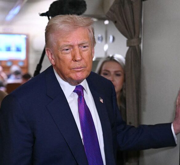 US President Donald Trump speaks to reporters on Air Force One before taking off from Joint Base Andrews, Maryland on February 19, 2026. Trump is travelling to Rome, Georgia to visit local businesses and give remarks about the economy at a steel factory. (Photo by SAUL LOEB / AFP via Getty Images)