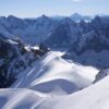CHAMONIX-MONT-BLANC, FRANCE - JULY 02: Alpinists descend along a narrow ridge of ice and snow from the Aiguille Du Midi peak at 3,800 meters towards the Col du Midi basin in the Mont Blanc massif mountain range on July 02, 2024 near Chamonix-Mont-Blanc, France. The Col du Midi is part of the accumulation zone that contributes ice to the Mer de Glace, Europe's fourth biggest glacier and 12km long. The Mer de Glace, like nearly all of Europe's glaciers, is melting fast. According to glaciologists the Mer de Glace lost 800 meters in length between 1993 and 2018, as well as 120 meters in depth at its lower region. While Europe's glaciers have been steadily receding since the Little Ice Age that ended in the mid 19th-century, periods of intermittent glacier growth extended into the 1980s. Since then the glaciers have been receding rapidly, with the pace of melting accelerating sharply in the last decade. Scientists blame global warming, which is extending and intensifying the summer melting season of the glaciers. Diminished annual snowfalls are leaving the glaciers more exposed to the sun and preventing the formation of new ice. (Photo by Sean Gallup/Getty Images)