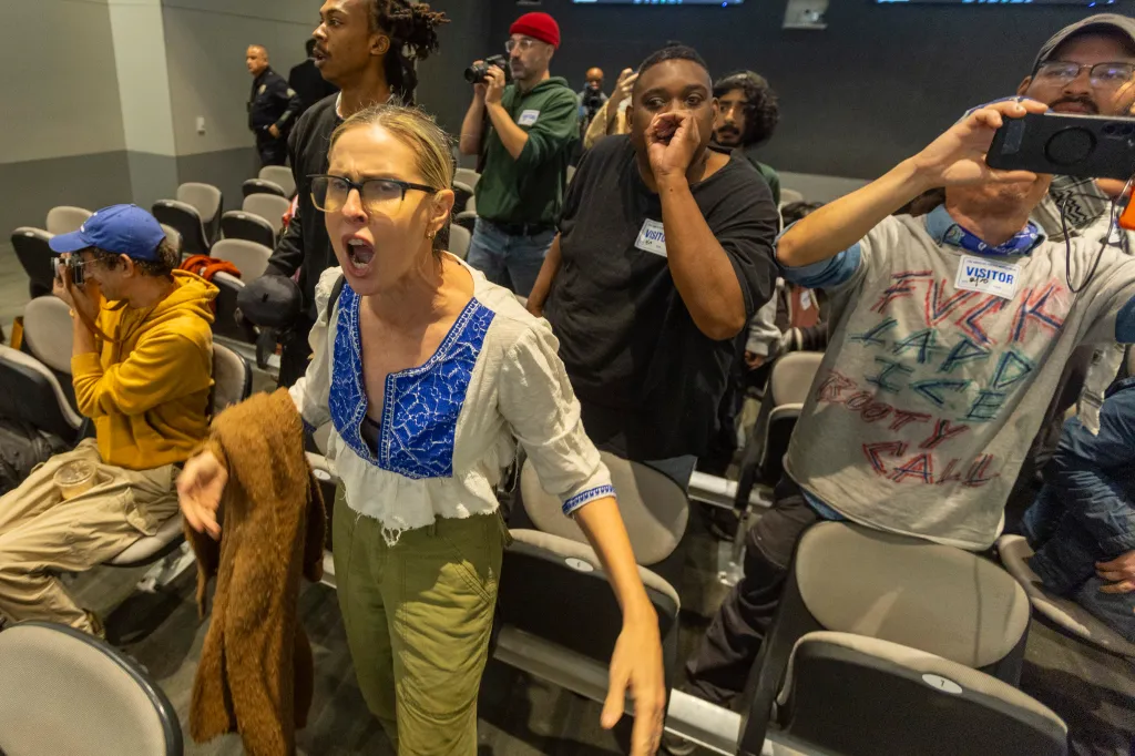Attendees yell during a recess at the Los Angeles Board of Police Commissioners meeting.
